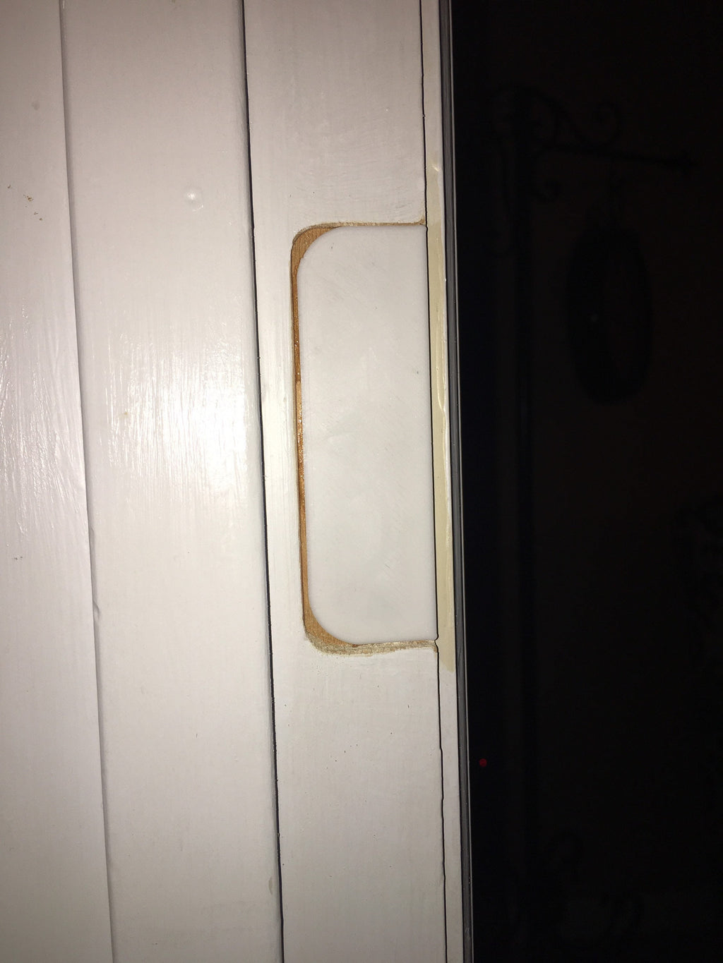 Door hinge filler installed in old hinge mortise on door jamb ready for spackle